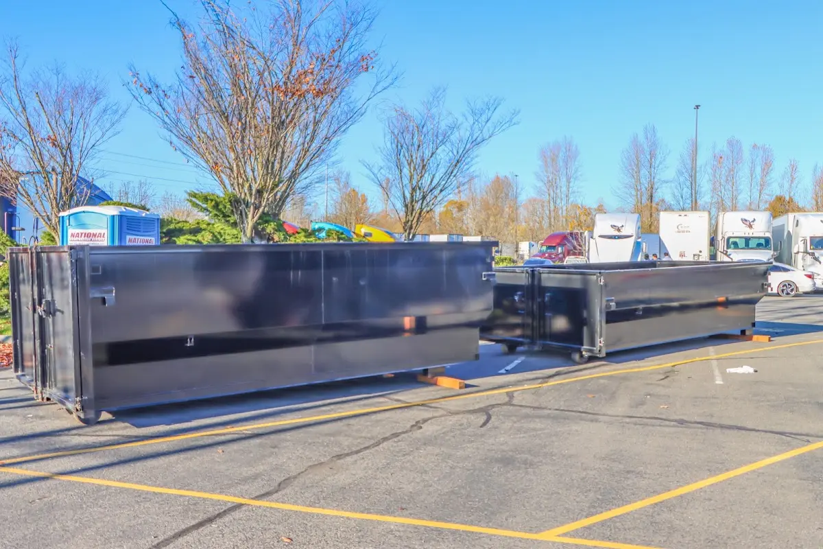 Professional dumpster rental service with roll-off container on residential driveway in Merriam